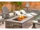 Close up of fire pit with lounge chairs and partial view of in-ground pool at 12430 Foxtail Run Ave, Las Vegas, NV 89138