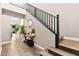 Hallway featuring stairs, modern decor, wood-like flooring, and access to other rooms at 12430 Foxtail Run Ave, Las Vegas, NV 89138