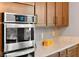 Gourmet kitchen featuring built in stainless appliances, granite countertops, and wood cabinets at 12430 Foxtail Run Ave, Las Vegas, NV 89138