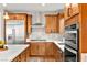 Well-lit kitchen with stainless steel appliances, white countertops, and wood-tone cabinetry at 12430 Foxtail Run Ave, Las Vegas, NV 89138