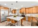 Bright kitchen featuring stainless appliances, island with seating, and adjacent dining space at 12430 Foxtail Run Ave, Las Vegas, NV 89138