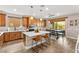 Open kitchen with island, stainless appliances, wood floors, and adjacent dining area with backyard view at 12430 Foxtail Run Ave, Las Vegas, NV 89138