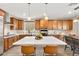 Beautiful kitchen with an island, modern appliances, sleek countertops, and a dining area at 12430 Foxtail Run Ave, Las Vegas, NV 89138