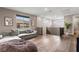 Spacious living area with hardwood floors, comfortable sofa and large windows at 12430 Foxtail Run Ave, Las Vegas, NV 89138