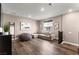 Spacious living area with hardwood floors, comfortable sofa and large windows at 12430 Foxtail Run Ave, Las Vegas, NV 89138