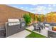 Outdoor kitchen with built in BBQ grill and a cozy seating area near the pool and fire pit at 12430 Foxtail Run Ave, Las Vegas, NV 89138