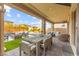 Inviting covered patio with outdoor dining, fire pit, and lounge area, perfect for relaxing and entertaining at 12430 Foxtail Run Ave, Las Vegas, NV 89138