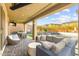 Outdoor patio with wicker furniture, a tv, an outdoor kitchen area, pool and spa combo in the background at 12430 Foxtail Run Ave, Las Vegas, NV 89138