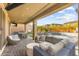 Outdoor patio with wicker furniture, a tv, an outdoor kitchen area, pool and spa combo in the background at 12430 Foxtail Run Ave, Las Vegas, NV 89138