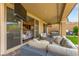 Outdoor patio with wicker furniture, a tv, an outdoor kitchen area, and glass doors at 12430 Foxtail Run Ave, Las Vegas, NV 89138