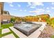 Backyard oasis featuring a pool, spa, waterfall, outdoor kitchen and grassy area at 12430 Foxtail Run Ave, Las Vegas, NV 89138