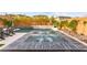 Backyard oasis featuring a pool, spa, waterfall, outdoor kitchen and grassy area at 12430 Foxtail Run Ave, Las Vegas, NV 89138