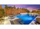 The swimming pool features in-pool lounge chairs, water feature, and a basketball hoop for endless entertainment and relaxation at 12430 Foxtail Run Ave, Las Vegas, NV 89138
