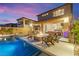 The covered patio transitions to backyard with pool, spa, outdoor kitchen and fire pit to complete the resort-style setting at 12430 Foxtail Run Ave, Las Vegas, NV 89138