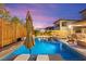 This resort-style pool includes a spa, built-in seating, sun loungers, fire pit, and a basketball court for ultimate leisure at 12430 Foxtail Run Ave, Las Vegas, NV 89138