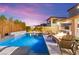 Inviting pool area with a fire pit, basketball hoop, and outdoor seating promises endless summer fun and relaxation at 12430 Foxtail Run Ave, Las Vegas, NV 89138