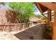 Inviting backyard featuring a brick-paved patio, a decorative brick wall, and lush greenery at 1252 Casa Palermo Cir, Henderson, NV 89011