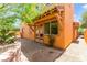 Charming backyard with stucco exterior, a brick-paved patio, and a mature, shady tree at 1252 Casa Palermo Cir, Henderson, NV 89011