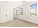 Bedroom featuring neutral carpet, a mirrored closet, and natural light at 1252 Casa Palermo Cir, Henderson, NV 89011