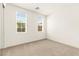 Bedroom featuring neutral carpet and two large windows at 1252 Casa Palermo Cir, Henderson, NV 89011