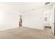 Bright bedroom with neutral carpet, featuring a bathroom entrance and hallway access at 1252 Casa Palermo Cir, Henderson, NV 89011