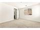 Large bedroom with neutral carpet, ensuite bathroom, and a bright window at 1252 Casa Palermo Cir, Henderson, NV 89011