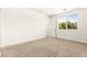 An empty bedroom features neutral carpet, white walls, and a window at 1252 Casa Palermo Cir, Henderson, NV 89011