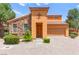 Charming home exterior with stone accents, a tile roof, and a neatly paved driveway at 1252 Casa Palermo Cir, Henderson, NV 89011