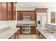 Elegant kitchen featuring granite countertops, stainless steel appliances, and custom cabinetry at 1252 Casa Palermo Cir, Henderson, NV 89011
