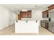 Open kitchen includes stainless steel appliances, granite countertops and island at 1252 Casa Palermo Cir, Henderson, NV 89011