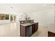 Modern kitchen featuring granite countertops, an island, and an open living area at 1252 Casa Palermo Cir, Henderson, NV 89011