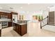Open floor plan featuring a modern kitchen with an island and a staircase at 1252 Casa Palermo Cir, Henderson, NV 89011
