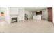 Spacious living area with a fireplace, open kitchen, and staircase leading upstairs at 1252 Casa Palermo Cir, Henderson, NV 89011