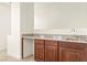 Stylish wet bar featuring dark wood cabinetry, granite countertop, and a stainless steel sink at 1252 Casa Palermo Cir, Henderson, NV 89011