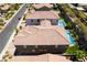 Aerial view of backyard featuring a pool, landscaped yard, and tiled roof at 133 Clouded Ave, Henderson, NV 89002