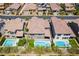 Aerial view featuring backyards with pools, playgrounds, and manicured lawns at 133 Clouded Ave, Henderson, NV 89002