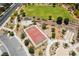 Overhead view of a community basketball court with a green field, playground, and walking paths for recreation at 133 Clouded Ave, Henderson, NV 89002