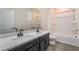 Bathroom featuring double sinks, modern fixtures, and a shower-tub combination at 133 Clouded Ave, Henderson, NV 89002