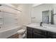 Bright bathroom with dark cabinets, marble countertops, and a shower-tub combo at 133 Clouded Ave, Henderson, NV 89002