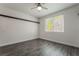 This bedroom has hardwood floors and a large beam running across the top of the wall and a backyard view at 133 Clouded Ave, Henderson, NV 89002