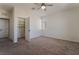 Bedroom with carpet flooring, ceiling fan, and walk-in closet with built-in shelving at 133 Clouded Ave, Henderson, NV 89002
