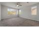 Bright bedroom with two windows, neutral paint, and plush carpeting at 133 Clouded Ave, Henderson, NV 89002