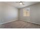 Neutral-toned bedroom with plush carpeting, ceiling fan and a window with bright natural light at 133 Clouded Ave, Henderson, NV 89002