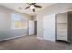 Bright bedroom featuring carpet flooring, a ceiling fan, and a closet with built-in storage at 133 Clouded Ave, Henderson, NV 89002