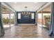 Open dining space with stylish lighting, wood accent wall, and sliding glass doors at 133 Clouded Ave, Henderson, NV 89002