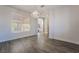 Bright dining room with wood-look flooring, chandelier, and views to the backyard and staircase at 133 Clouded Ave, Henderson, NV 89002