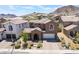 Charming two-story home with a tile roof, desert landscaping, and a two-car garage in a Gathering-friendly neighborhood at 133 Clouded Ave, Henderson, NV 89002