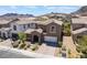 Beautiful home with a well-manicured front yard, attached two-car garage, and stunning mountain views at 133 Clouded Ave, Henderson, NV 89002