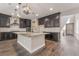 Beautiful kitchen featuring a granite island, designer pendant lights, and stainless steel appliances at 133 Clouded Ave, Henderson, NV 89002