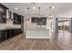 Modern kitchen with granite countertops, a center island, stainless steel appliances, and dark cabinetry at 133 Clouded Ave, Henderson, NV 89002